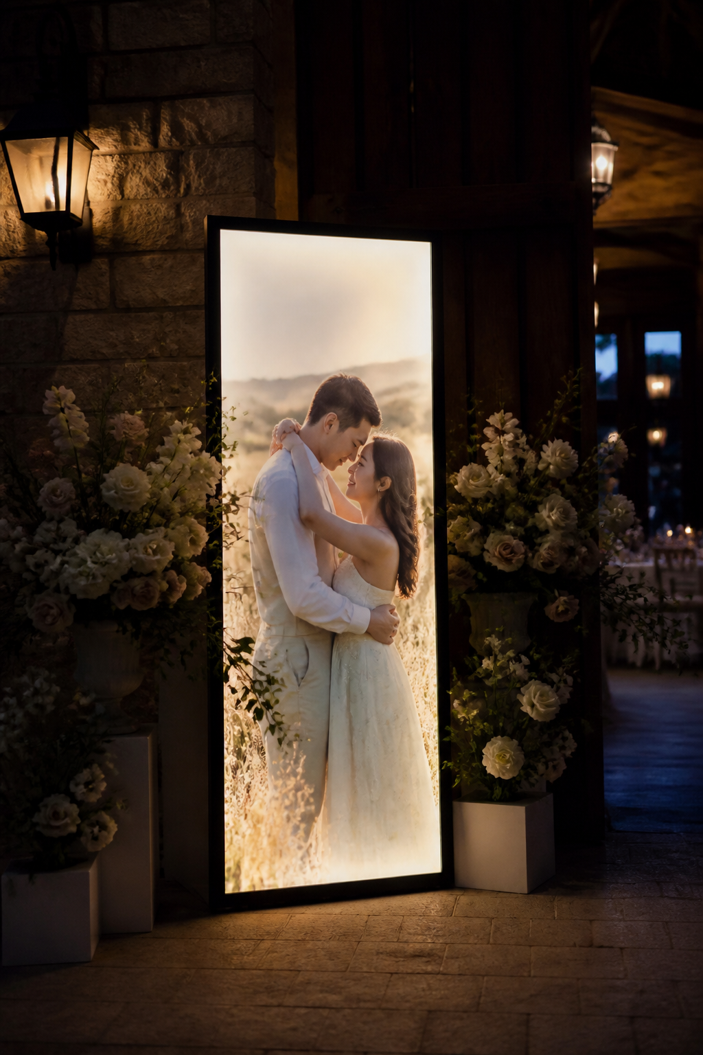 Glowing engagement photo flanked by florals at a venue entryway